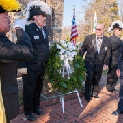 William Murray lays wreath at memorial during celebration of religious freedom, as honor guard from the Knights Templar and Knights of Columbus salute.