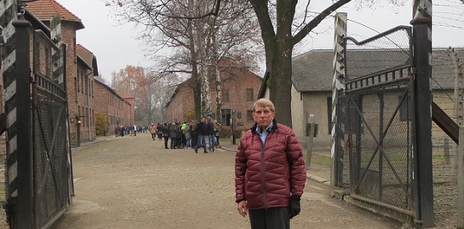 William J. Murray at the gate of Auschwitz which read "Work makes freedom," but the only freedom those who entered ever received was death.